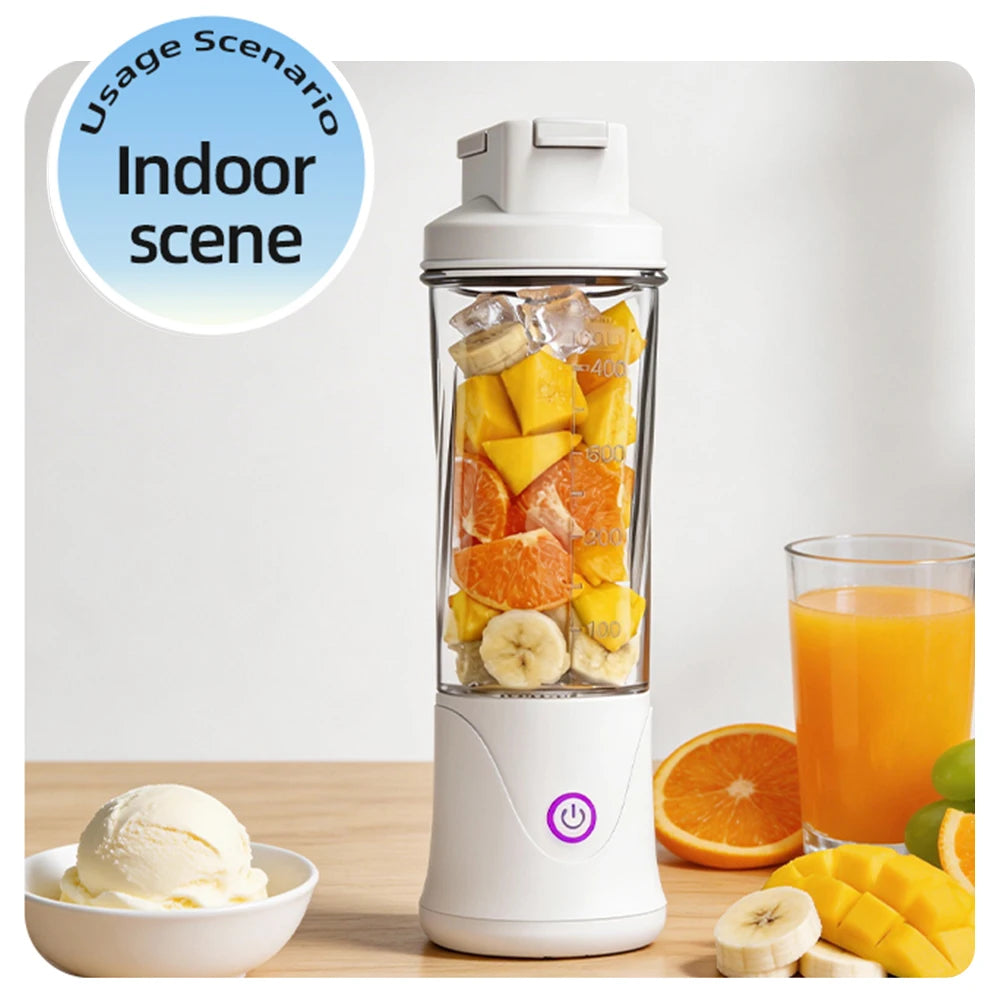 Portable white blender filled with fresh fruit slices, sitting on a table with fruit and a bowl of ice cream nearby.