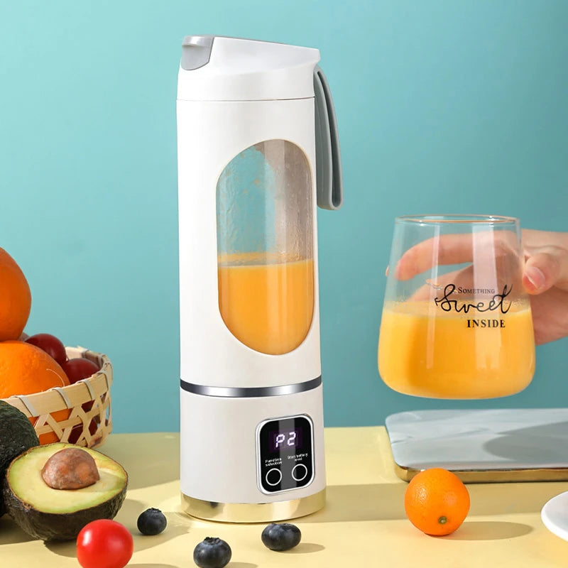 White portable blender with a clear window, digital display, and grey carrying strap, containing orange juice.