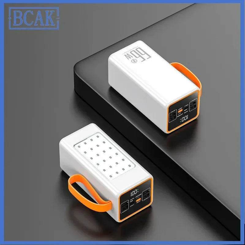 White portable power bank with orange carry strap, LED display, and multiple charging ports. Features an integrated light.
