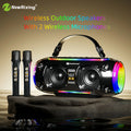 Portable black wireless Bluetooth speaker with LED lighting and two matching microphones on a stone base.