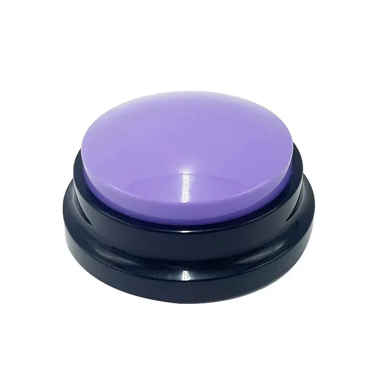 A round, recordable dog training button with a glossy purple top and a black base, isolated on a white background.