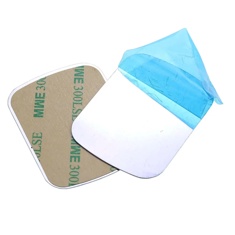 Two square adhesive mounting pads with rounded corners, silver metallic surface, and blue protective film.