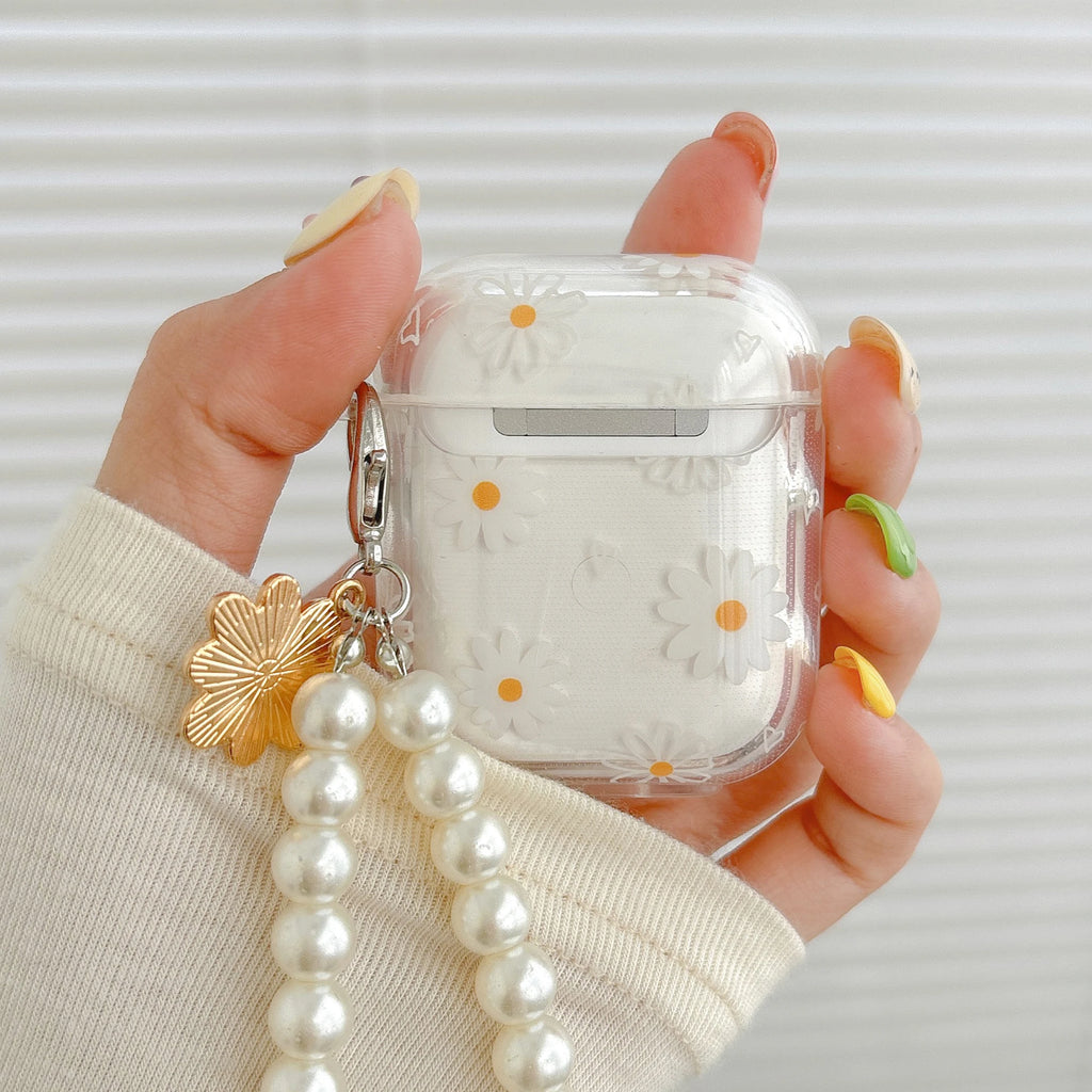 Clear protective case for AirPods with white daisy print, pearl charm, and metal clip.