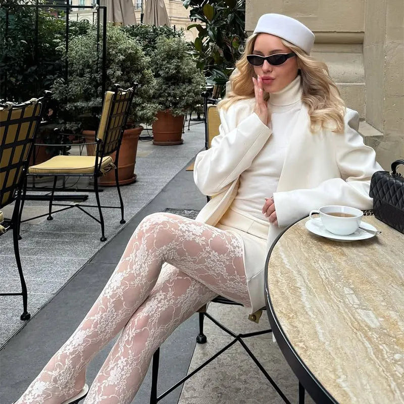 Elegant white wool Hepburn-style bucket hat worn by a woman in an all-white outfit.