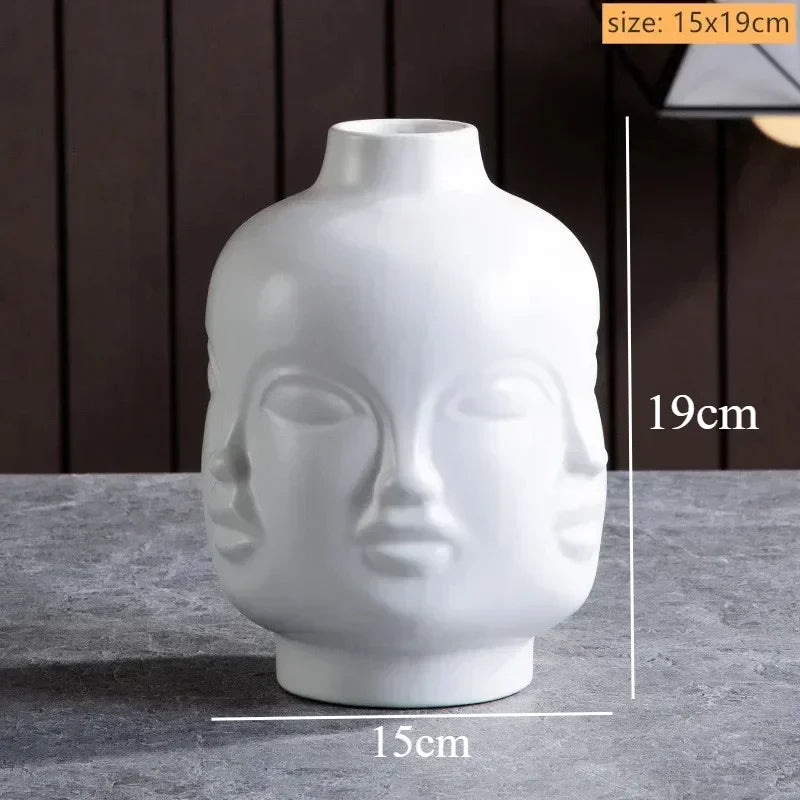 White ceramic vase featuring a minimalist multi-face design, 15cm wide by 19cm tall. Modern artistic decor.