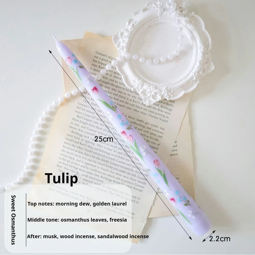 Lavender taper candle, 25cm tall, featuring a delicate painted tulip floral pattern. Elegant aesthetic decor.