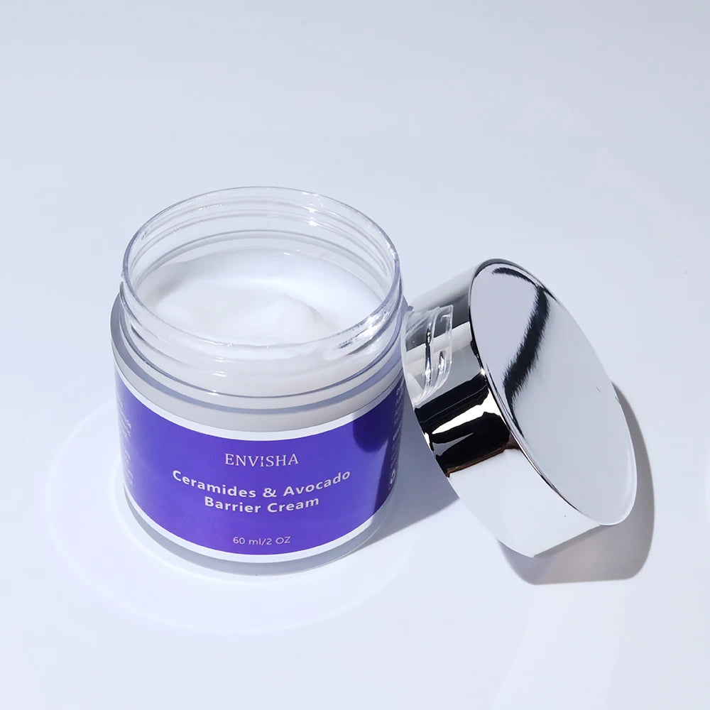 Open jar of white Ceramides & Avocado face barrier cream, 60ml, with a purple label and reflective silver lid.