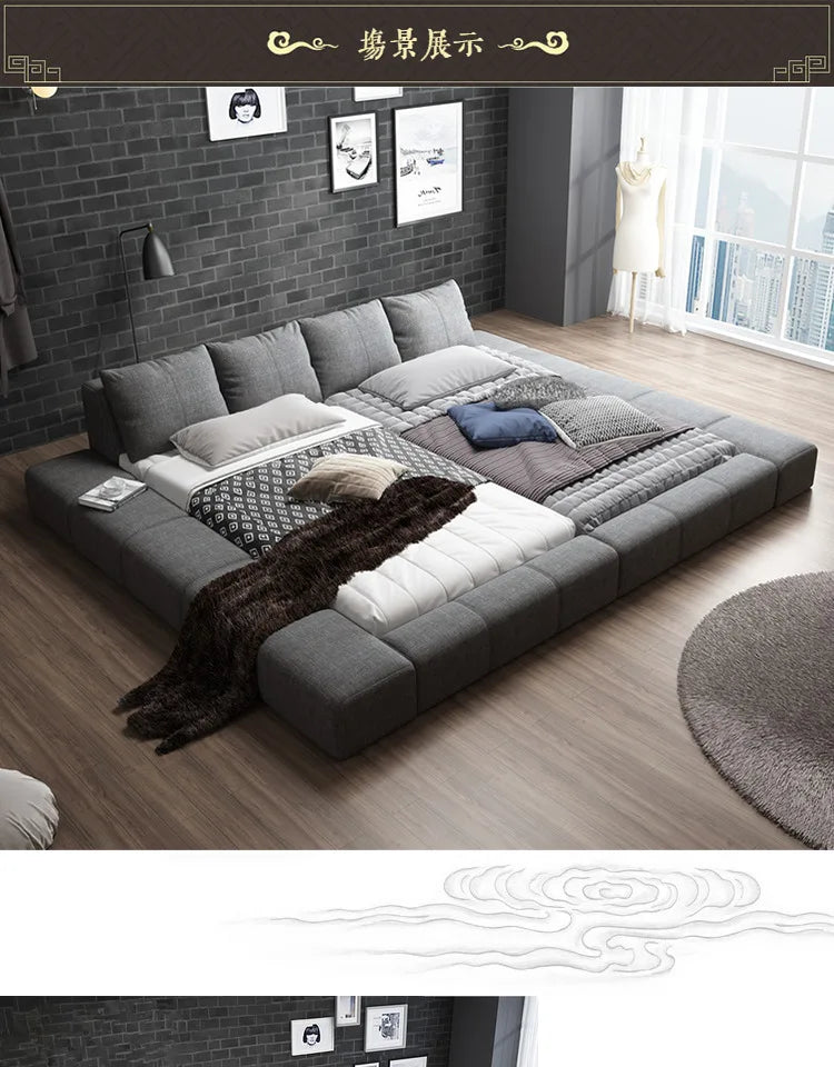 Modern grey fabric double bed with a low-profile padded frame and backrest cushions in a contemporary bedroom.