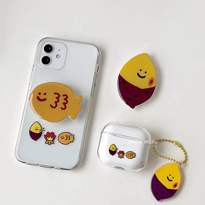 Clear silicone AirPods case with cute sweet potato character print and matching yellow ball chain charm.
