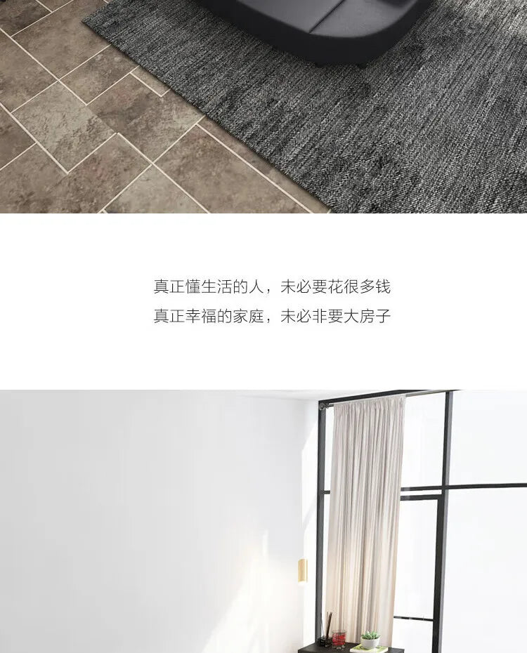 Modern black upholstered bed with integrated storage, set on a dark textured rug in a contemporary room.
