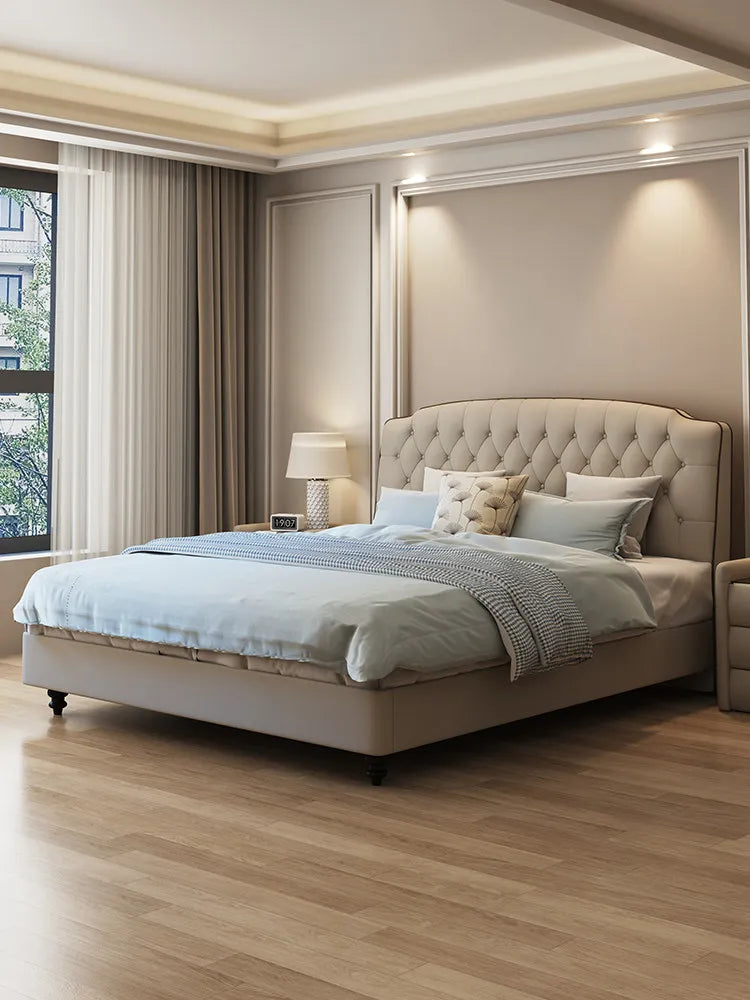 Luxury beige upholstered queen bed frame with a button-tufted arched headboard in a modern bedroom setting.