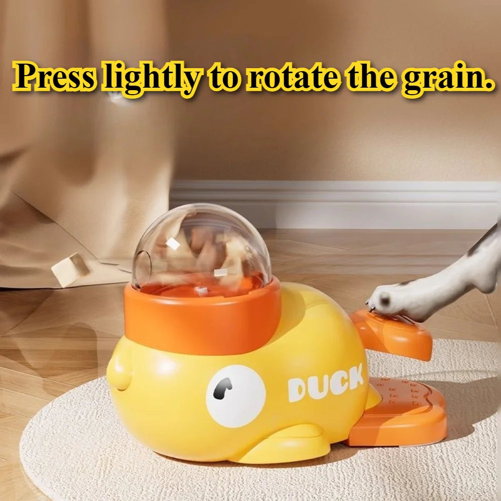 Yellow duck-shaped interactive pet toy with a clear dome that dispenses treats when a pedal is pressed.