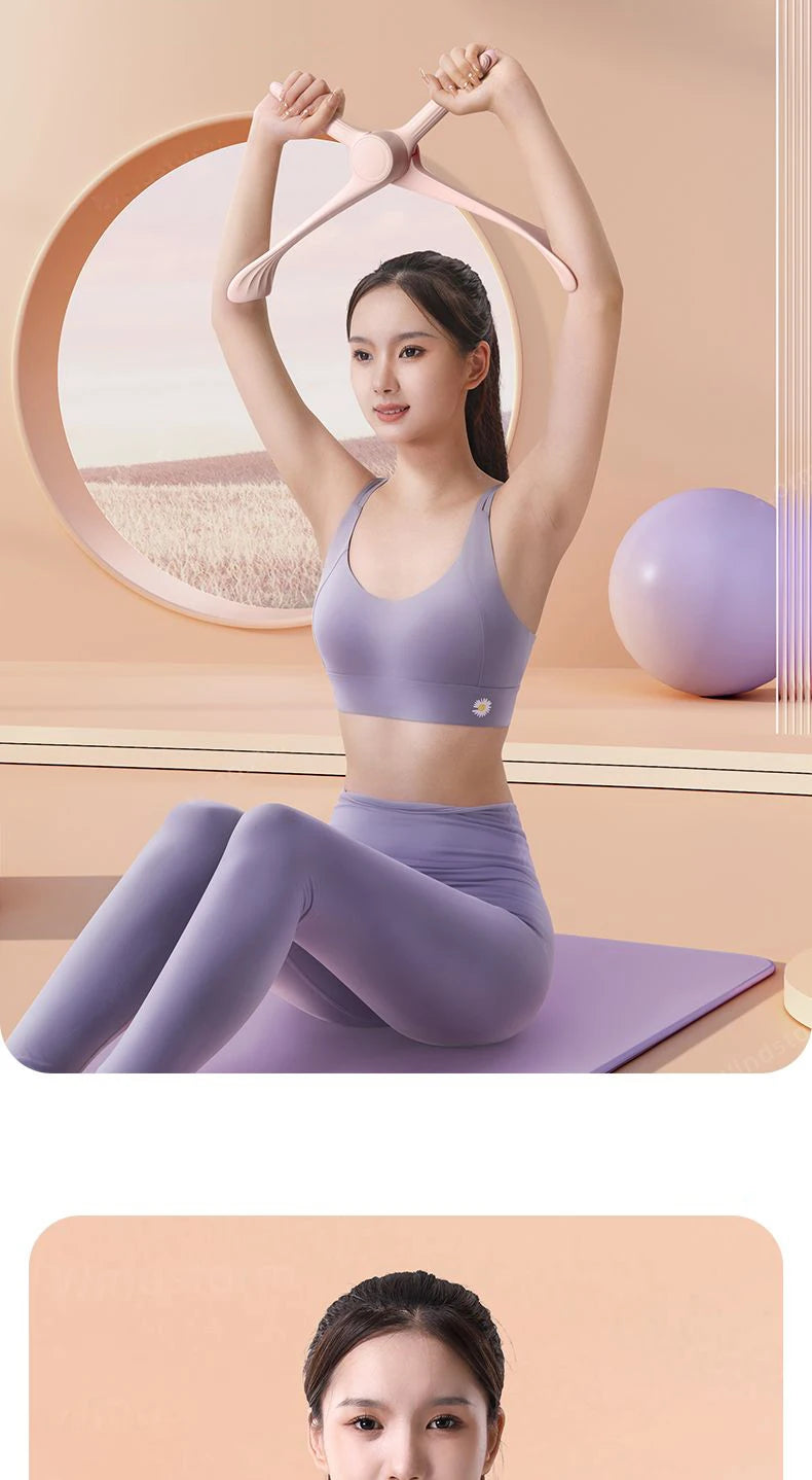 A woman in lilac activewear using a pale pink, Y-shaped multifunctional arm training tool whilst on a yoga mat.