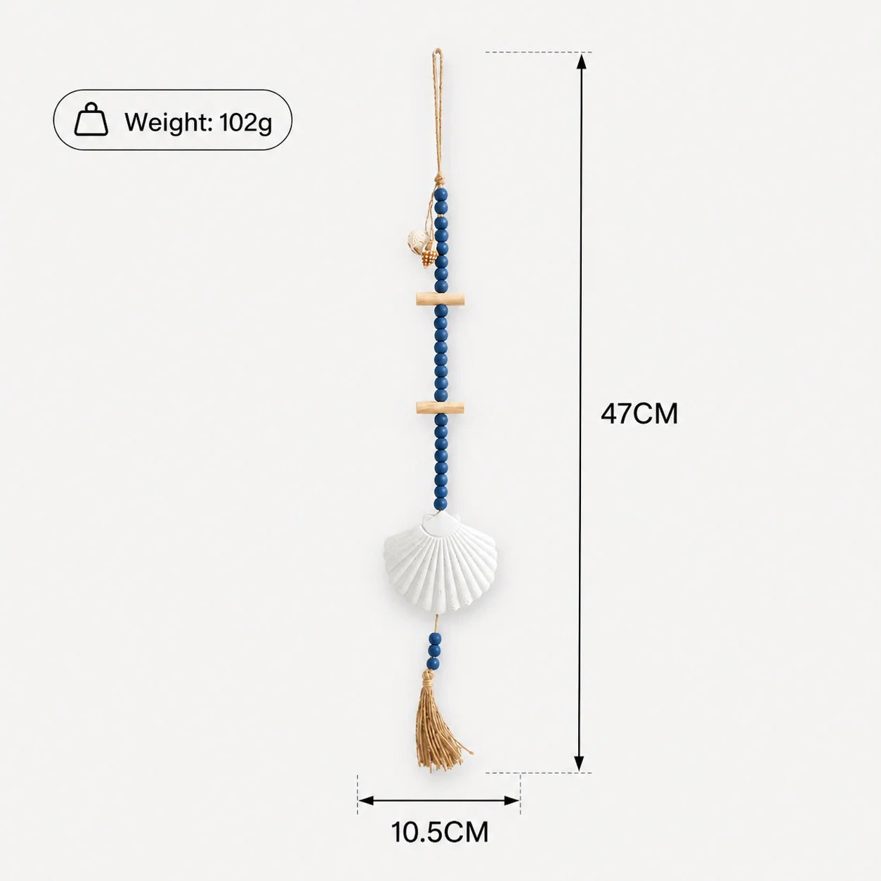 Boho wall hanging with blue wooden beads, light wood accents, a white seashell centrepiece, and a natural fibre tassel.