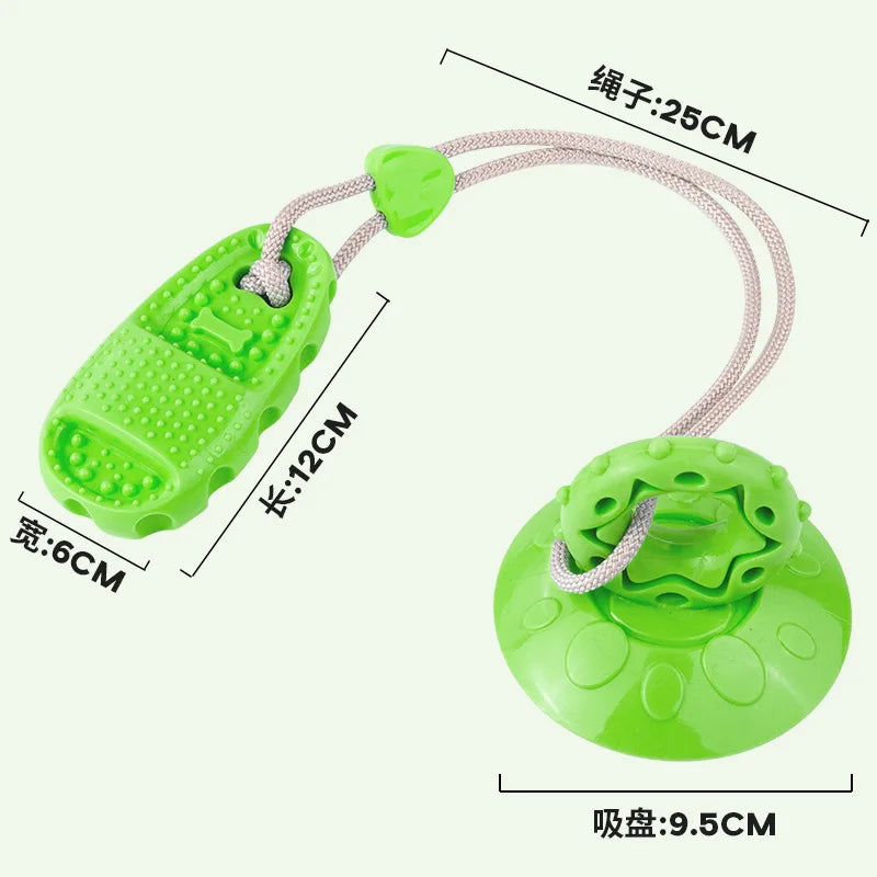 Bright green interactive dog toy with a durable suction cup base, textured chew toy, and sturdy connecting rope.