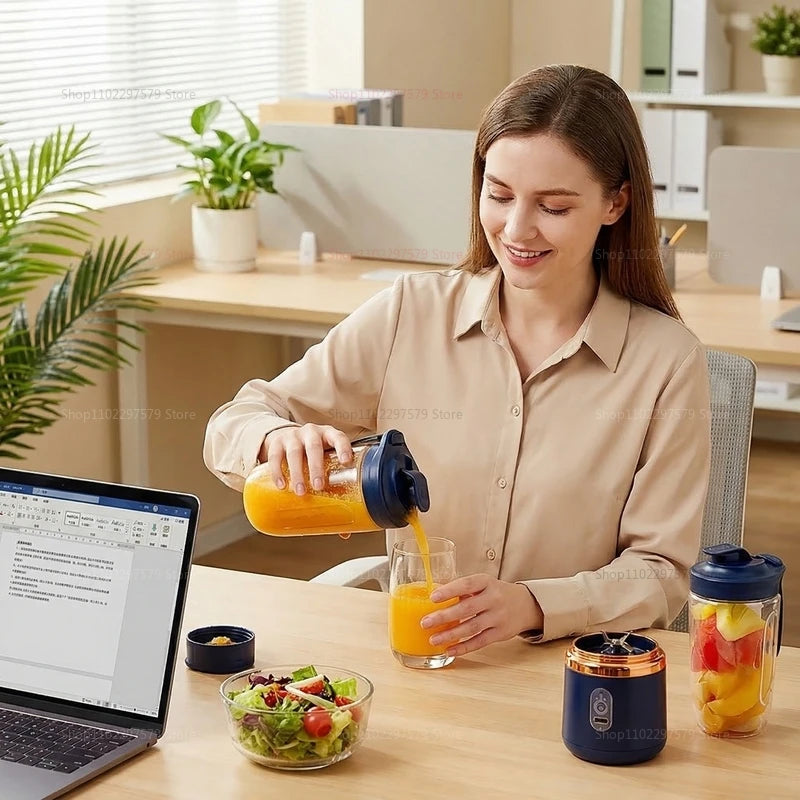 A woman in an office pouring orange juice from a portable, dark blue and clear personal blender into a glass.