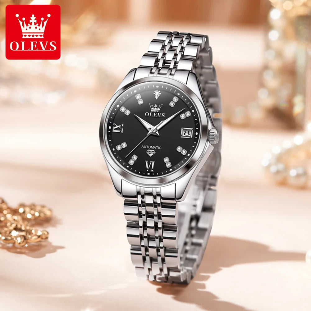Elegant stainless steel automatic women’s watch with a black dial, crystal hour markers, and a date display.