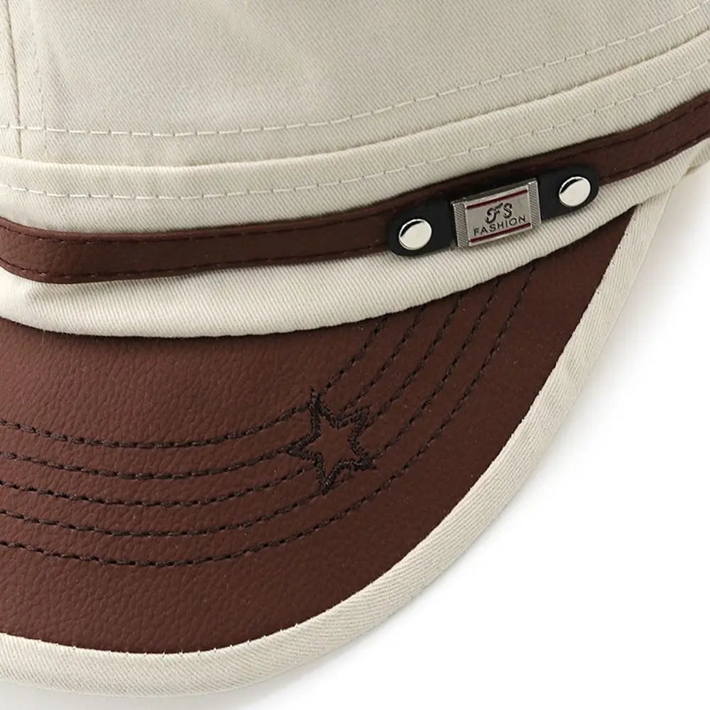 Cream-coloured baseball cap with a brown faux-leather peak, star stitching detail, and a decorative trim with studs.