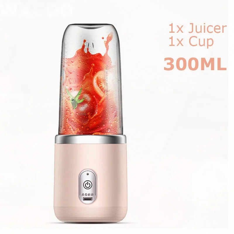 Portable 300ml personal juicer in matte pink with a clear cup containing blended red tomato juice.
