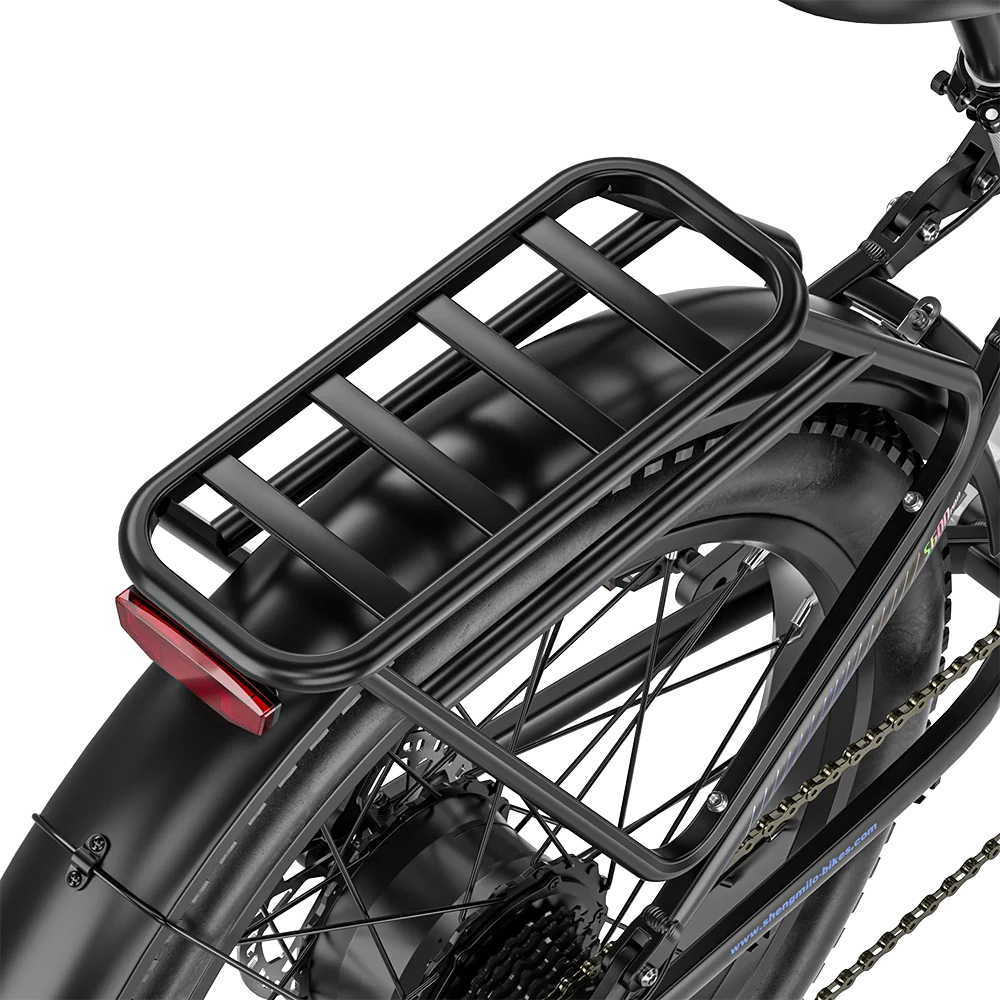 Black adult mountain e-bike rear cargo rack over a wide fat tire with fender and red taillight.
