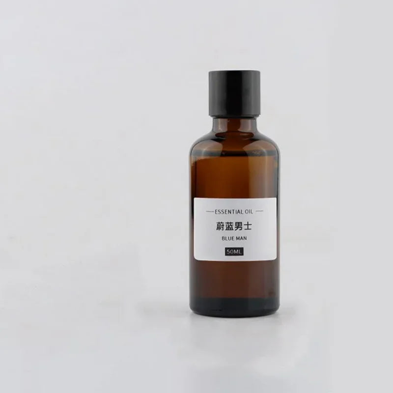 50ml amber glass essential oil bottle with a black screw cap and a minimalist white label on a white background.
