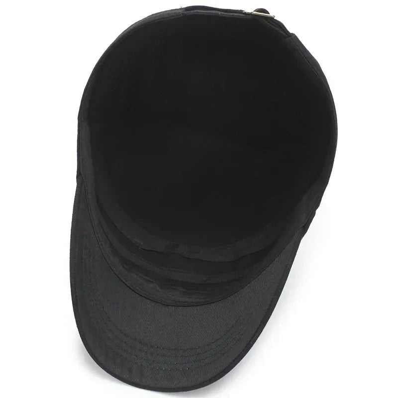 Top-down view of a black cotton military-style cap with a flat top, curved peak and adjustable metal buckle strap.