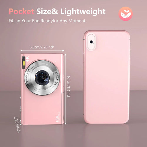 Small, pink digital camera with a 16x zoom lens, 48MP sensor, and flash, shown next to a pink smartphone.