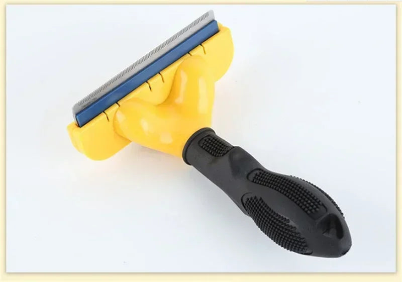 Pet de-shedding tool with a yellow head, blue metal fine-tooth blade, and a textured black ergonomic rubber handle.