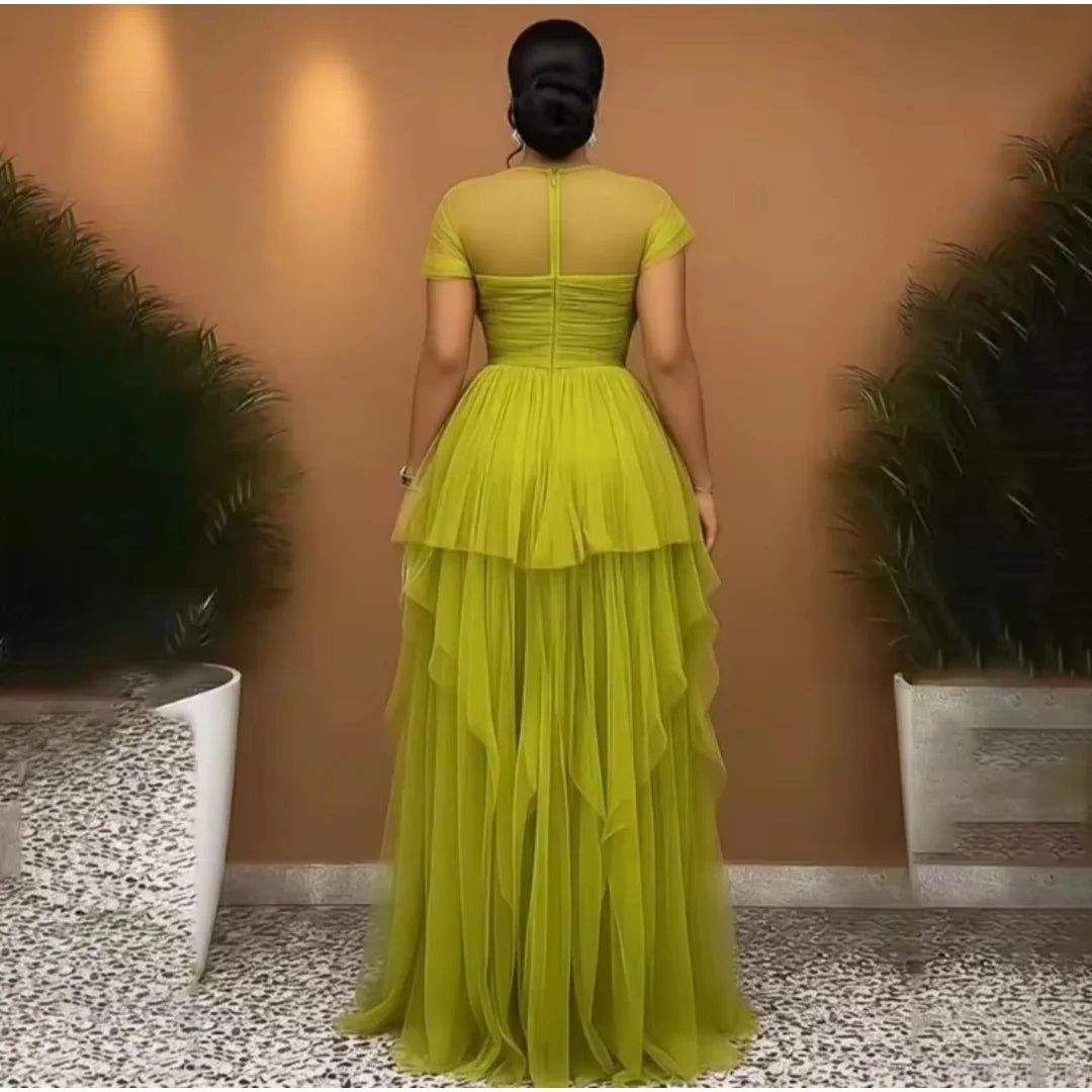 Olive green tulle evening gown featuring short sheer sleeves, a ruched bodice, and ruffled tiers.