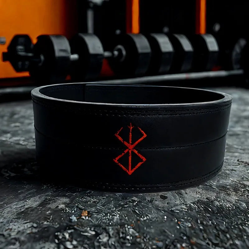 A wide black leather weightlifting belt with a red embroidered symbol in the center.