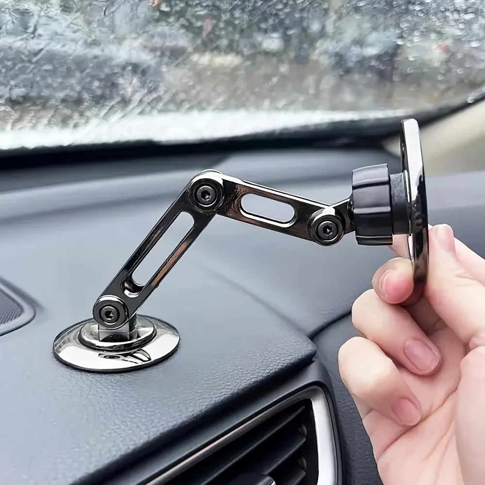 Gunmetal car phone mount with adjustable folding arm, mounted on a dashboard base with a circular magnetic head.