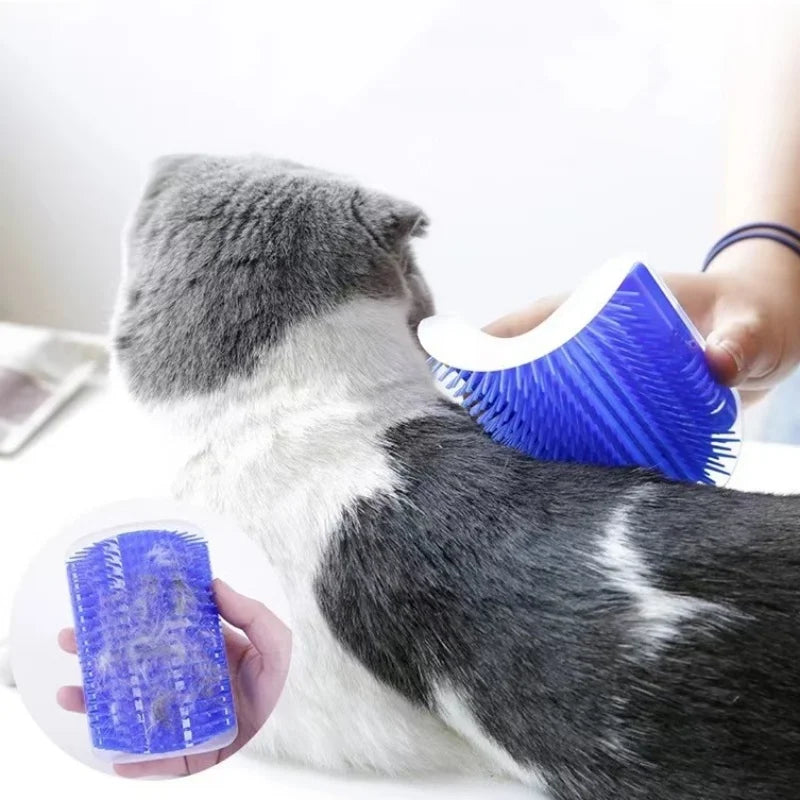 A hand using a blue, curved silicone brush to groom a grey and white cat, with an inset showing collected loose fur.