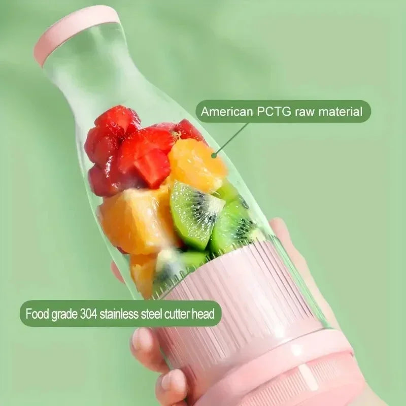 Portable pink and clear personal blender filled with fresh cut strawberries, oranges, and kiwi.