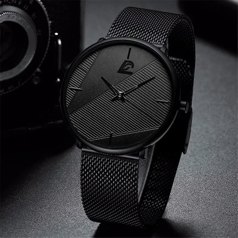 Minimalist men's ultra-thin quartz watch in matte black with a mesh strap and textured, geometric dial.