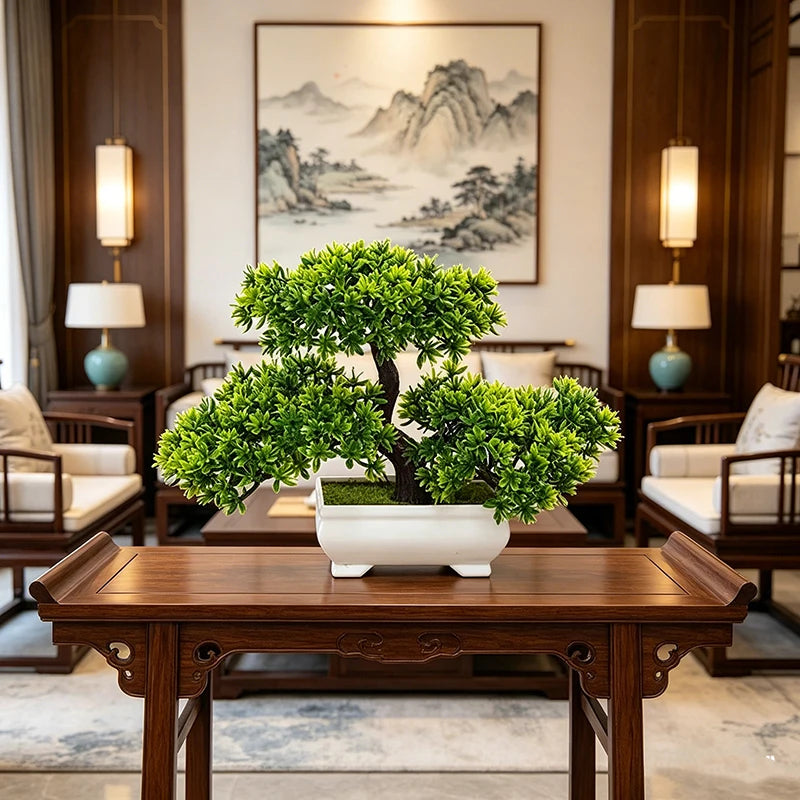 Artificial bonsai tree with vibrant green foliage in a minimalist white rectangular pot on a wooden table.