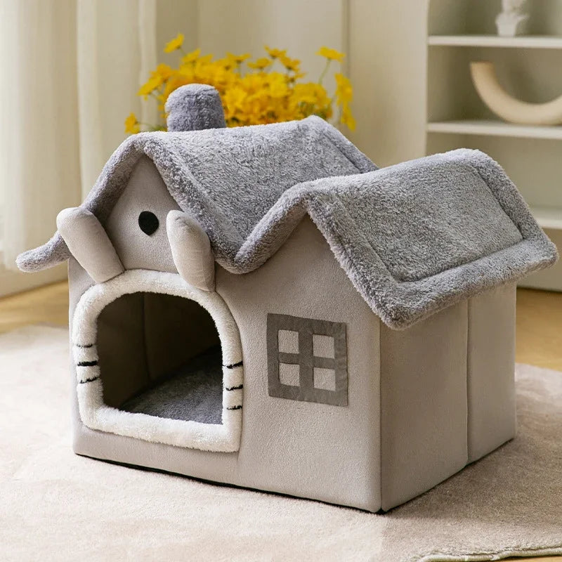 Grey plush foldable pet house shaped like a cottage with a fuzzy roof, chimney, and window detail.