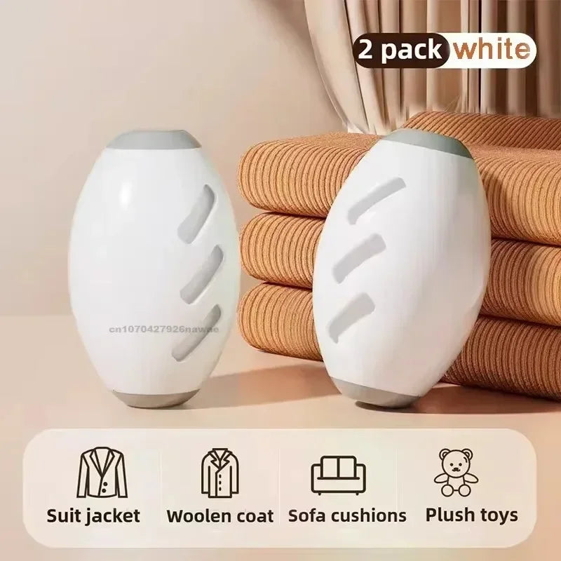 Two white, oval-shaped laundry balls with grey caps, designed to remove lint and hair from fabrics.