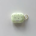 Pale green polka dot AirPods Pro case in glossy plastic with a matching side keyring.