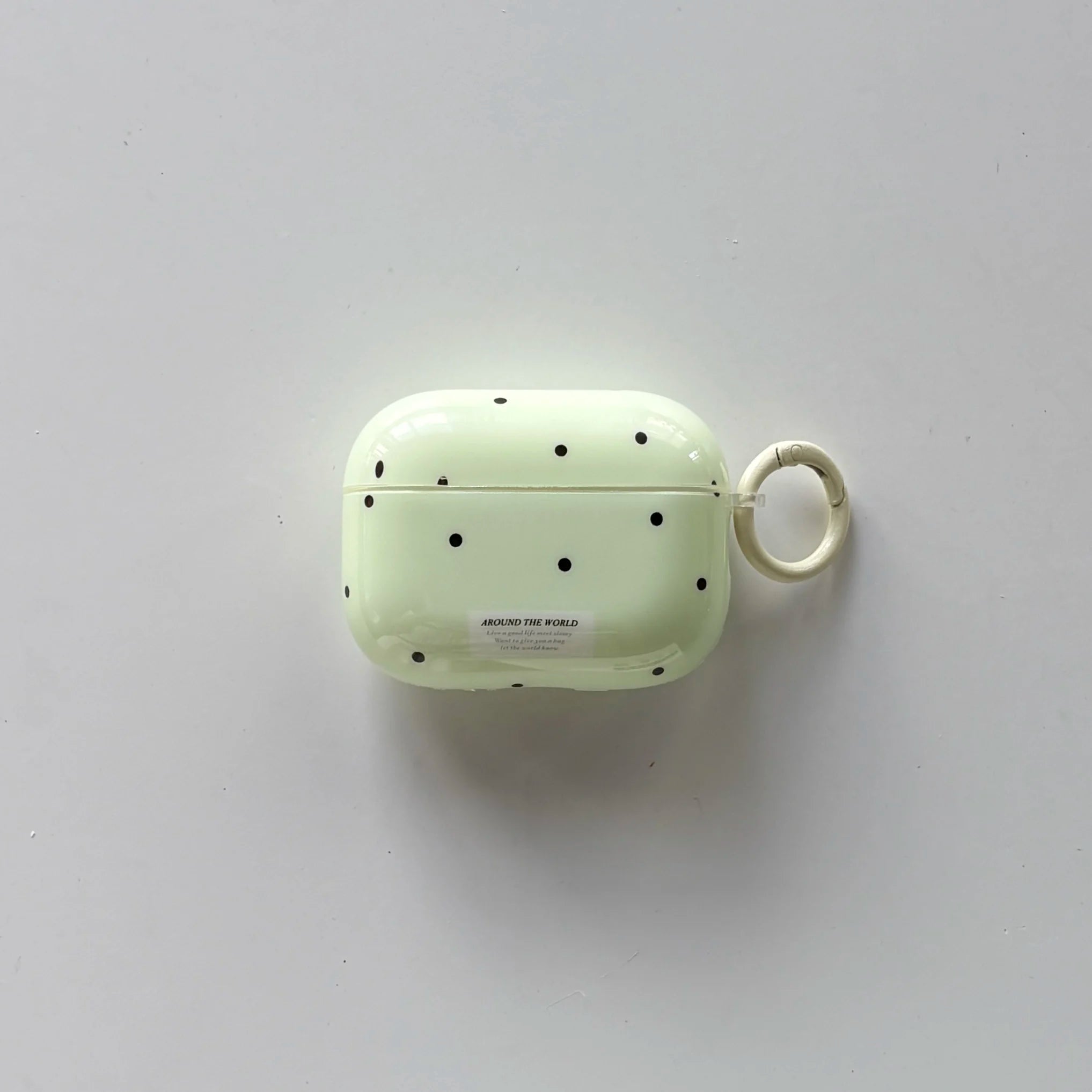 Pale green polka dot AirPods Pro case in glossy plastic with a matching side keyring.