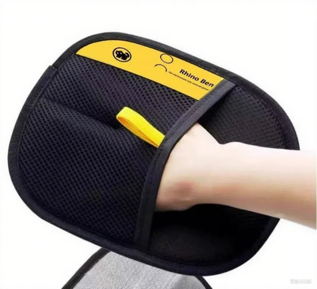 Black and yellow mesh Rhino Ben pet hair removal grooming mitt worn on a hand.