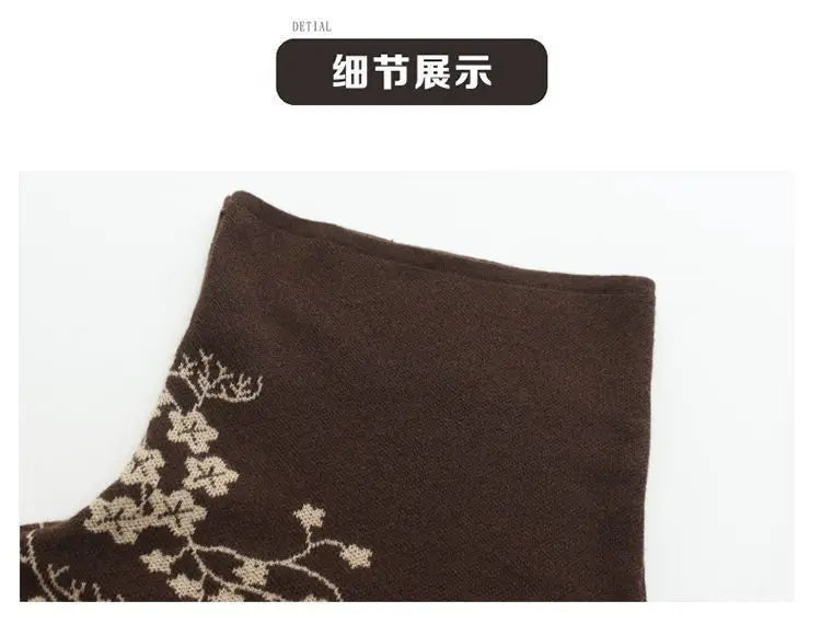 Close-up of a brown knitted fabric featuring an elegant, contrasting cream-coloured floral pattern.