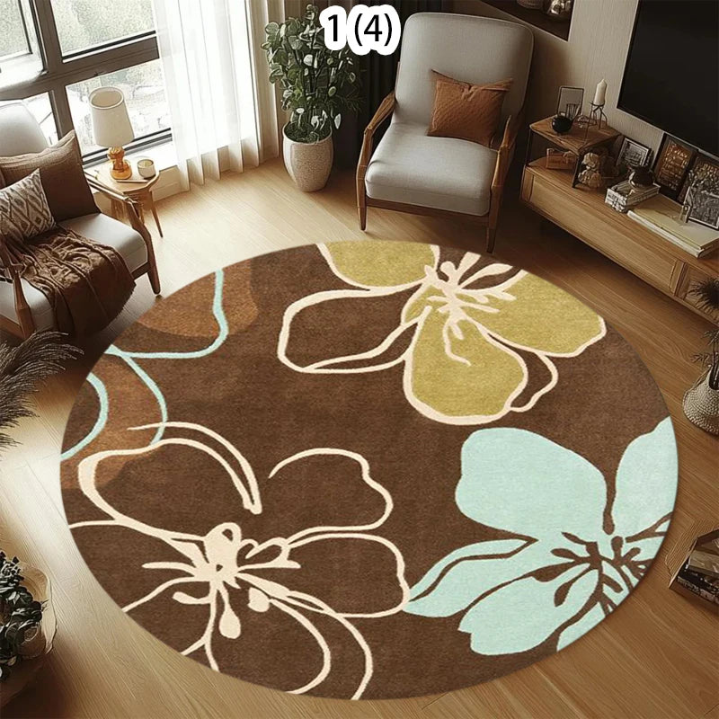 Round rug with modern abstract floral pattern in brown, sage green, and light blue on a wooden living room floor.