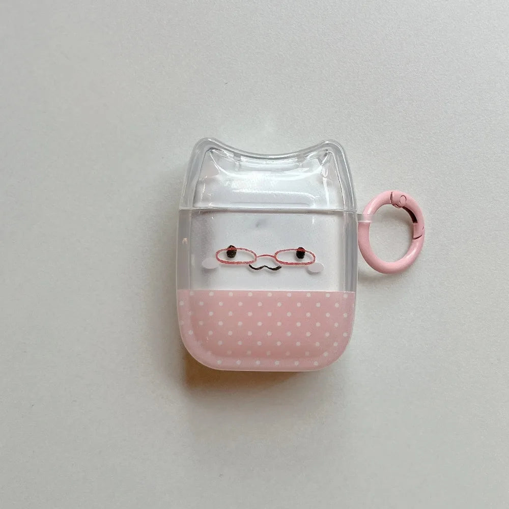 Clear cat-ear AirPods case with pink polka-dot base, glasses character design, and matching pink keyring.