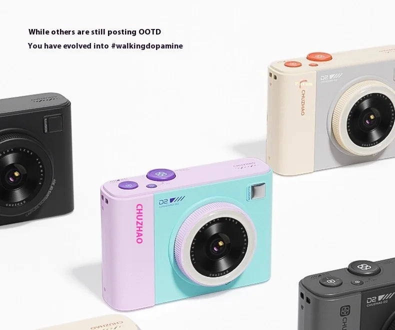 Four plastic Chuzhao D2 digital cameras in black, cream, purple, and mint green with round lenses and top buttons.