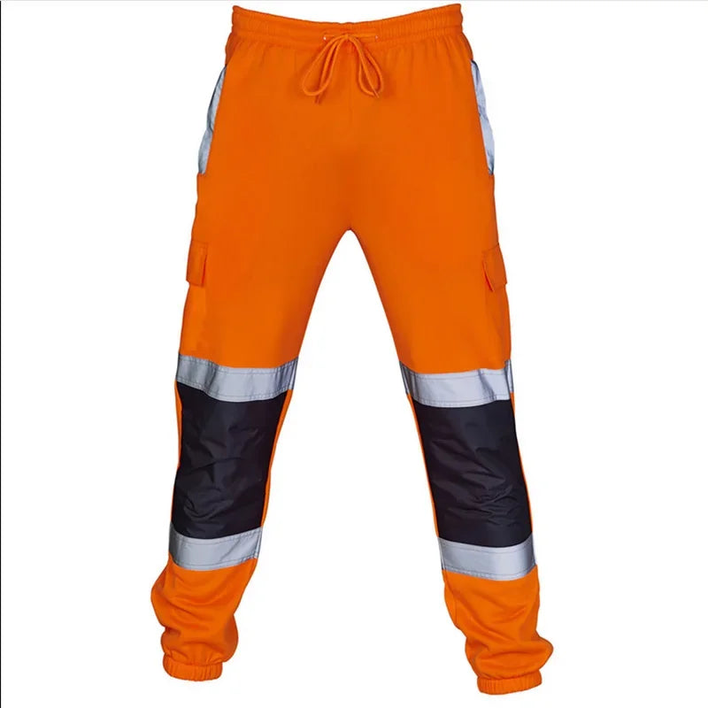 Men's orange high-visibility joggers with drawstring waist, black knee patches, and reflective side strips.