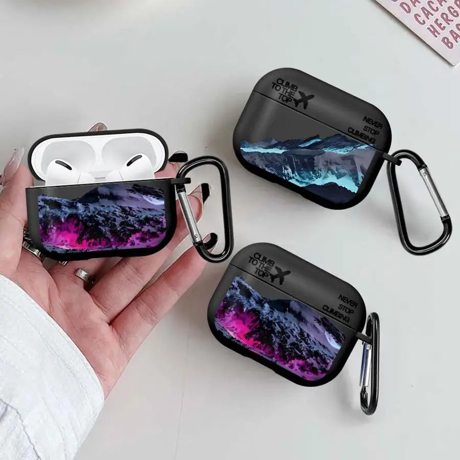 Black AirPods Pro case with mountain landscape print, "Climb to the Top" text and matching carabiner clip.
