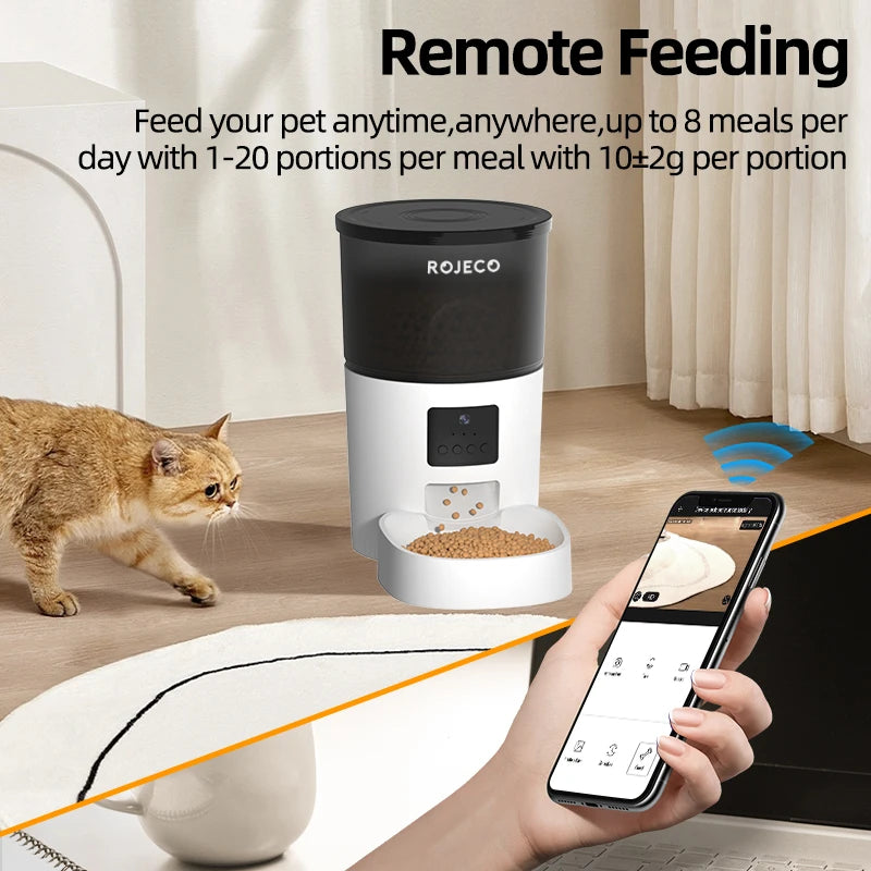 White and black smart automatic pet feeder with camera, controlled via a mobile app, shown with a cat and kibble.