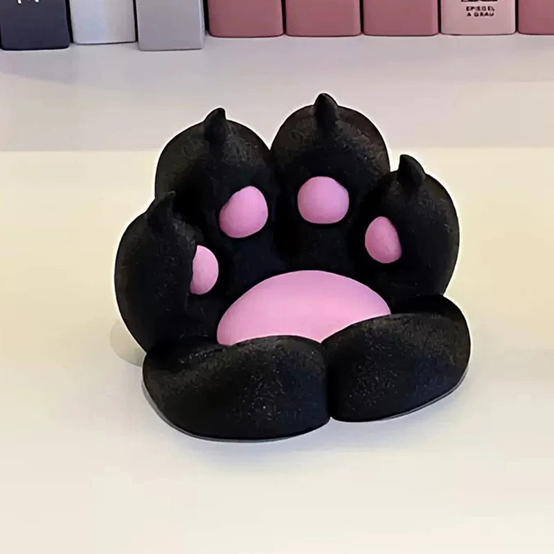 Black and pink cat paw-shaped desk accessory or phone stand with a soft, matte textured finish.