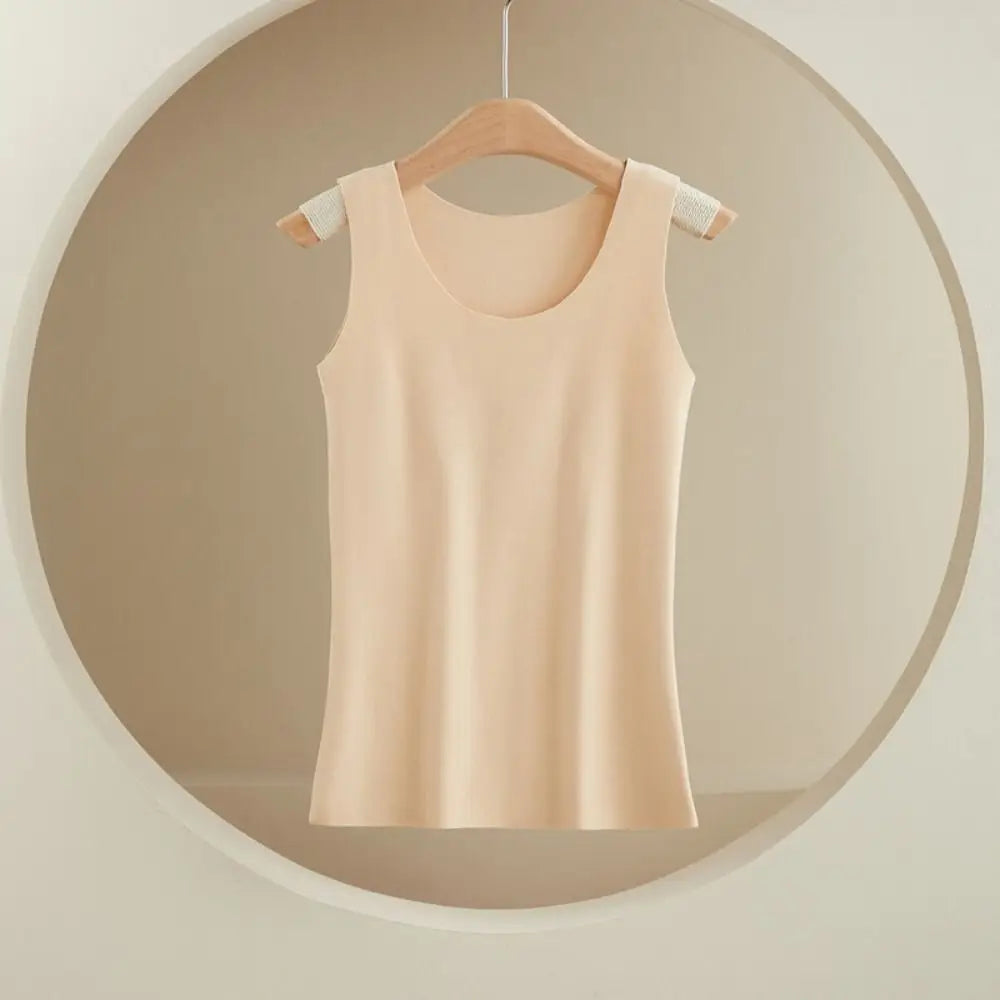 Beige sleeveless scoop-neck tank top on a wooden hanger, made from smooth, seamless material.