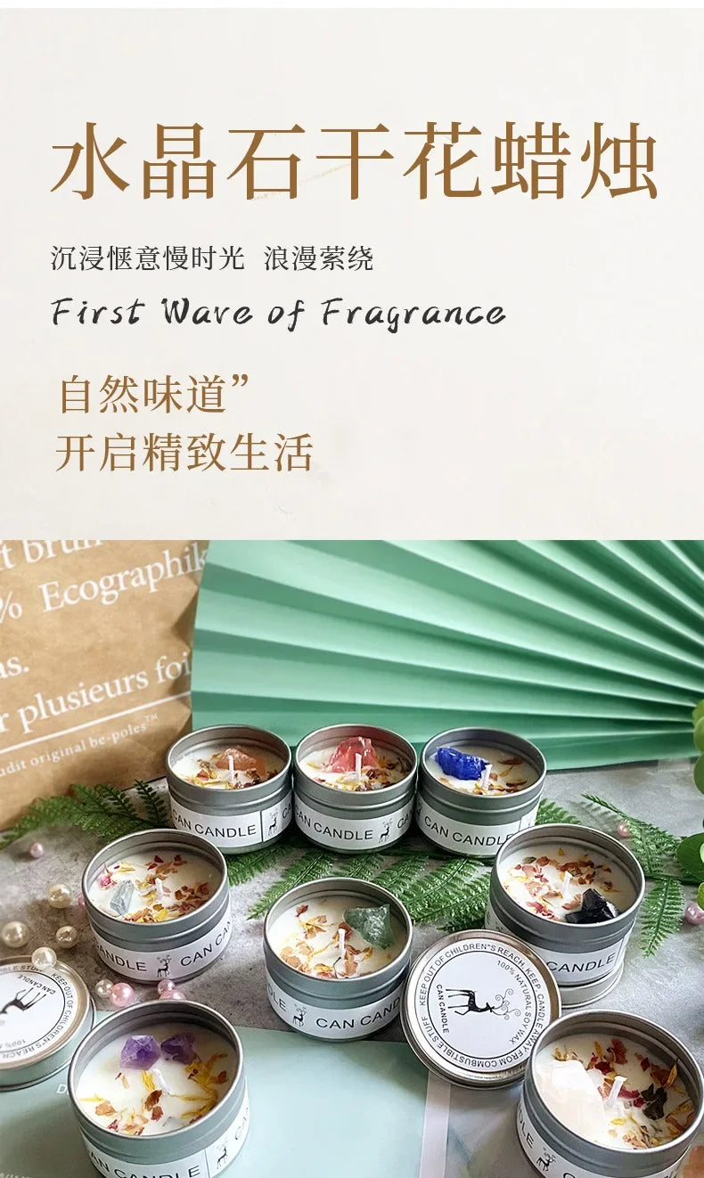 Set of scented soy candles in silver metal tins, decorated with dried flower petals and colorful crystal gemstones.